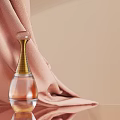 Elegant Fragrance Perfume Bottle With Transparent Body And Golden Neck On Pink Fabric Beige Background