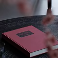 Red Cover Dessert The Art Of Recipe Book On Black Table With Floral Decoration