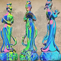 Three Colorful Traditional Female Statues As Garden Ornaments With Vibrant Hues And Intricate Details