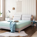 Double Bed With Light Green Mattress Gray Pillows Blue Side Table And White Fluffy Rug
