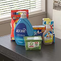 Daily Household Laundry And Cleaning Supplies With Bottles And Boxes On Dark Countertop