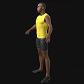 A man wearing yellow tank top and black shorts with arms outstretched against black background