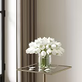 Transparent Vase With White Flowers On Glass Table Near Window With Curtain In Natural Light