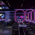 Modern Bar Interior Design With Neon Lights Counter Tables Chairs And Wine Racks