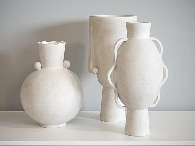 White Ceramic Vessels With Various Shapes And Matte Finish On White Tabletop Against Gray Wall 3d model
