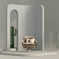 Beige Armchair with Pillow on Modern White Display Platform Featuring Green Cactus and Arched Structure