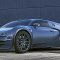 Metallic Blue Sports Car With Sleek Aerodynamic Design And Modern Building Background