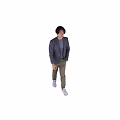 Man In Purple Plaid Blazer Gray Top And Brown Pants Stands Naturally Against Gray Background