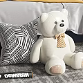 White Teddy Bear Doll with Geometric Pillow and Downtown Baseball Bat in Bedroom