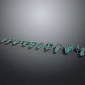 Green Shiny Decorative Gemstone Ornaments Arranged In Row On Dark Background