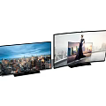 Modern Ultra Thin Televisions Showing City Skyline And Figure With Clear Display Screen