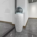 Transparent Spherical Glass Sculpture Placed On White Diamond Pattern Column With Marble Floor