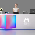 Modern Exhibition Reception Desk With Colorful Gradient Panel White Flower Bouquet Tablet Laptop And Staff