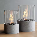 Two Transparent Glass Fireplaces With Gray Concrete Base Stones And Burning Flames On Wooden Table