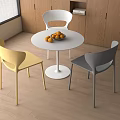 Modern Dining Table Set with Round White Tabletop Three Colored Chairs and Oranges on Top 3d model