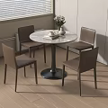 Round Dining Table with Four Brown Chairs and Vase Flowers Book Cup in Light Room