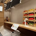 Fresh Fruit Store Interior Featuring Various Fruits on Shelves and Customers Selecting Produce