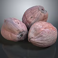 Three Pinkish Brown Coconuts on Dark Reflective Surface with Textured Skin