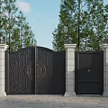 Elegant Black Entrance Gate With Ornate Carvings Stone Pillars And Lush Green Trees