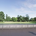 Ornamental White Fence Along Green Trees Grass With Blue Sky White Clouds