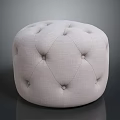 Round Tufted Ottoman With Light Fabric Upholstery And Simple Modern Design
