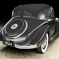 Classic Black Vintage Car With Round Headlights And Chrome Grille Design On Concrete Surface