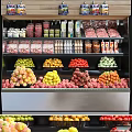 Fresh Various Fruits on Display in Supermarket Fruit Section with Apples Strawberries Oranges and Grapes