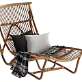 Wicker Chaise Lounge with Black and Gray Cushions and Black White Plaid Blanket