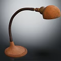 Brown Table Lamp With Curved Leather Arm And Woven Base Round Shade