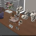 Elegant Perfume and Cosmetics Display on Wooden Table with Rabbit Figurines and Flowers