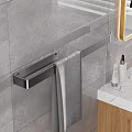 Modern Bathroom Accessory Arrangement With Metal Towel Rack Gray Towel Marble Countertop And Skincare Products