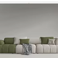 Modern Sectional Sofa with Green and Beige Plush Cushions and Cozy Throw Blanket