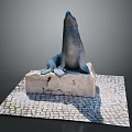 Detailed Seal Statue Perched On Weathered Stone Base With Cobblestone Pavement