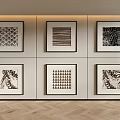 Six Black And White Framed Artworks On Wall With Herringbone Wooden Floor