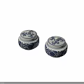 Pair of Blue and White Ceramic Jars With Floral Patterns and Lids