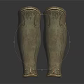 Antique Bronze Greaves With Intricate Carved Patterns On Black Reflective Surface