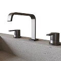 Modern Sleek Faucet Design With Dual Handles On Concrete Countertop