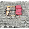 Red Metal Public Parking Lock Facility Installed On Paved Brick Road Surface
