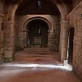 Cartoon Scene Of Ancient Stone Corridor With Arched Doors Stone Pillars And Top Window Light
