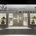Elegant Clothing Store Interior With Open Sign Hanging Clothes And Green Plants