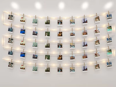 Photo Wall With Multiple Photos Arranged Using Clothespins And String Lights On White Wall 3d model