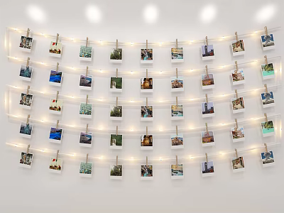 Photo Wall With Multiple Photos Arranged Using Clothespins And String Lights On White Wall 3d model