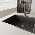 Modern Matte Black Kitchen Sink With Light Colored Countertop And Modern Faucet