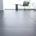 Modern Gray Floor Tiles In Bright Interior With Glass Table And Plant