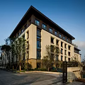Modern Multistory Residential Exterior With Green Landscape And Leisure Seating Area