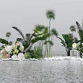 Lush Green Plants And Colorful Flowers By Water Surface With Pebbles And White Lantern