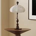 Vintage Table Lamp with White Floral Pattern Shade and Wooden Base on Round Side Table