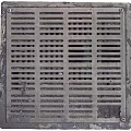 Road Facilities Metal Drainage Grate With Grid Pattern On Urban Street Surface