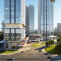 Modern Commercial Complex With Glass Facades Tall Buildings Roads Vehicles And Greenery