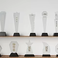 Trophies and Medals Transparent Shapes Engraved Champion Special Award First Prize Black Bases on Shelf